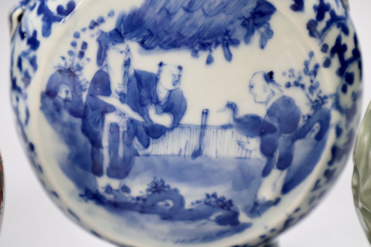 A Chinese blue and white moon flask, a Chinese celadon glazed moon flask and a famille verte baluster vase, tallest 21cm